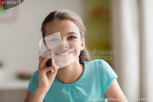 Image of close up of girl calling on smartphone at home