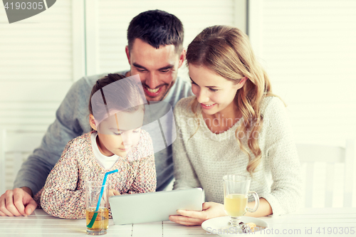 Image of happy family with tablet pc at restaurant