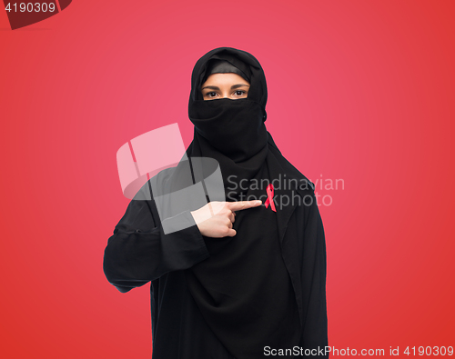 Image of muslim woman in hijab with red awareness ribbon