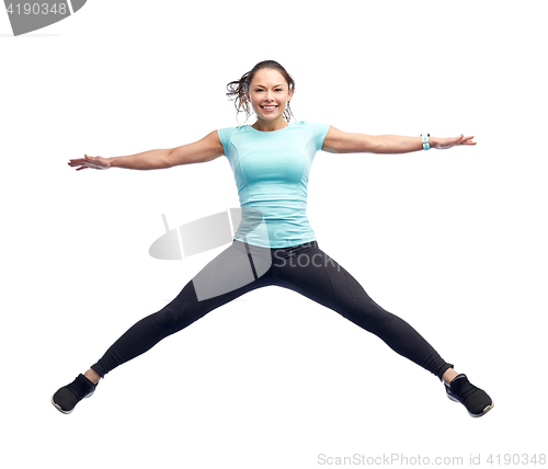 Image of happy smiling sporty young woman jumping in air