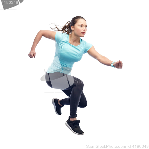 Image of happy sporty young woman jumping in air