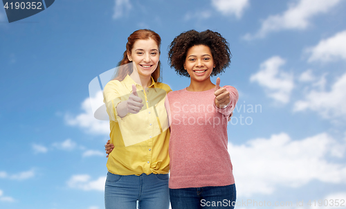 Image of happy smiling women showing thumbs up
