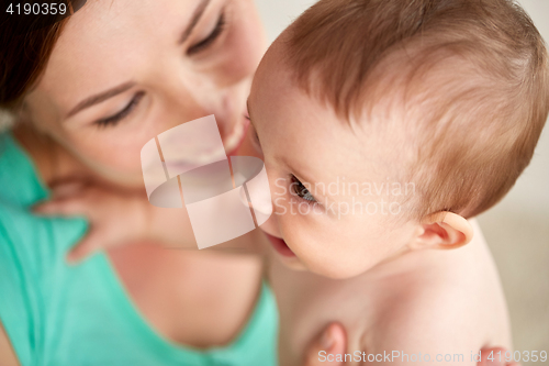 Image of happy young mother with little baby at home