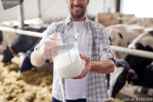 Image of man or farmer with cows milk on dairy farm