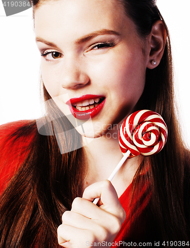 Image of young pretty brunette girl with red candy posing on white backgr