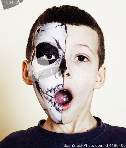 Image of little cute boy with facepaint like skeleton to celebrate hallow