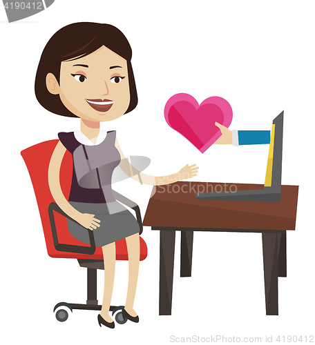 Image of Young woman dating online using laptop.