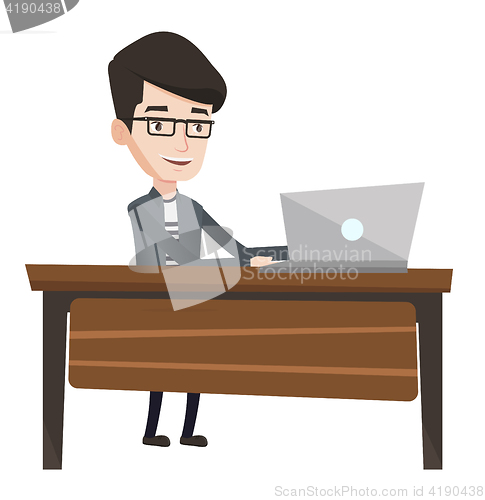 Image of Office worker working on laptop in office.