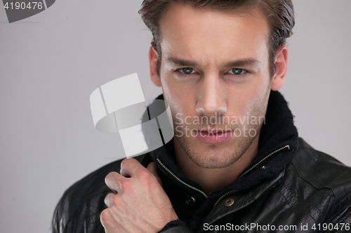 Image of portrait of a young guy over gray background