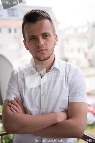 Image of man standing at balcony