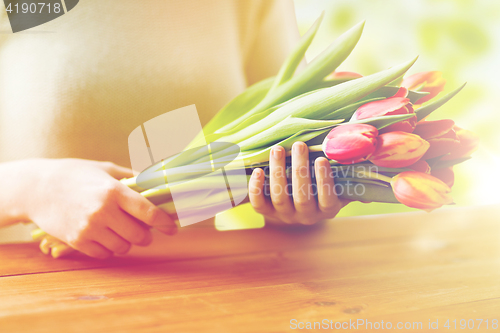 Image of close up of woman holding tulip flowers