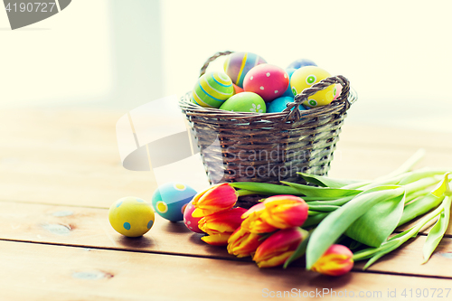 Image of close up of easter eggs in basket and flowers