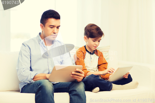 Image of father and son with tablet pc at home