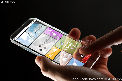 Image of close up of hand with apps on smartphone