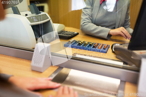 Image of clerk counting cash money at bank office