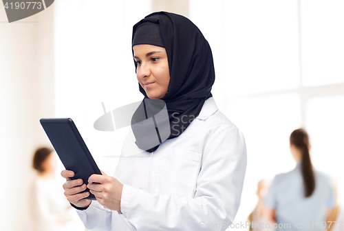 Image of muslim female doctor in hijab with tablet pc