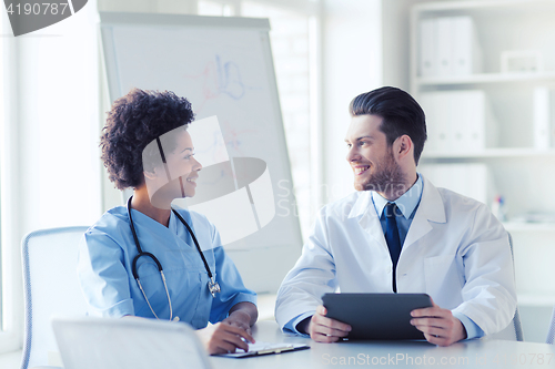 Image of two happy doctors meeting at hospital office