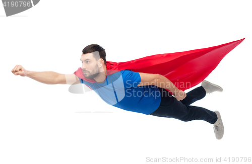 Image of man in red superhero cape flying on air