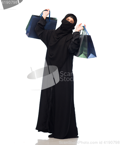 Image of muslim woman in hijab with shopping bags