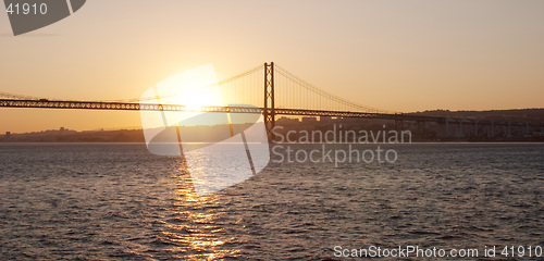 Image of Bridge 25 de Abril on river Tagus at sunset, Lisbon, Portugal