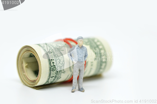 Image of Figure of businessman and one dollar bill