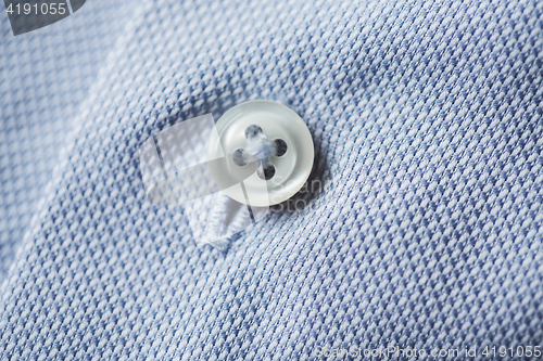 Image of close up of blue shirt button