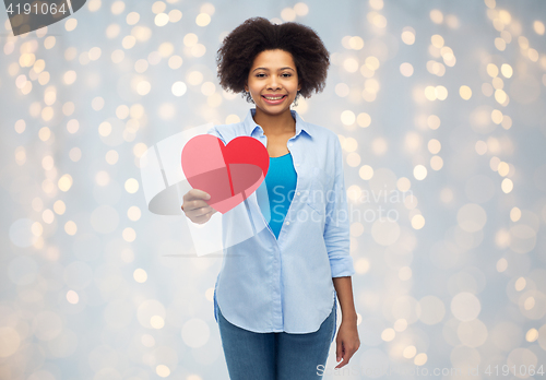 Image of happy african american woman with red heart shape