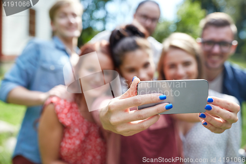 Image of friends with smartphone taking selfie at summer