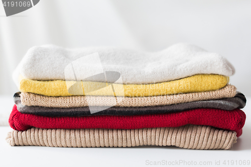 Image of close up of stacked knitted clothes