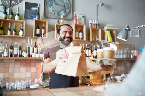 Image of man or waiter serving customer at coffee shop