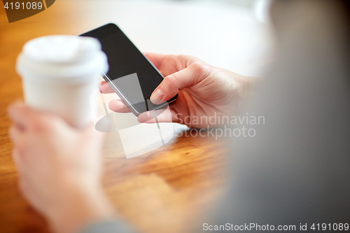 Image of close up of woman with smartphone and coffee