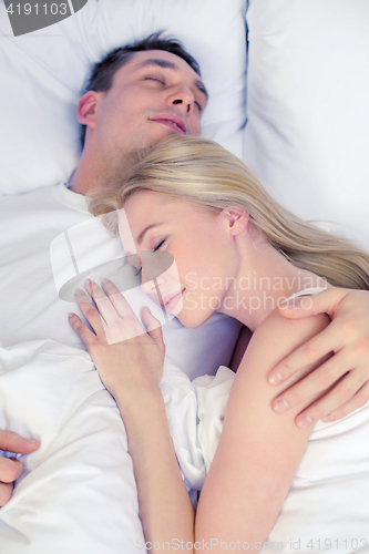 Image of happy couple sleeping in bed