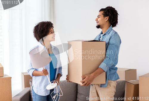 Image of happy couple with stuff moving to new home