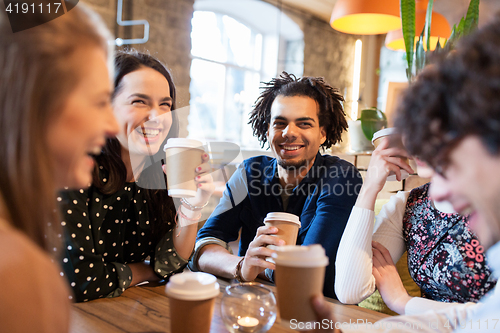 Image of happy friends drinking coffee at restaurant