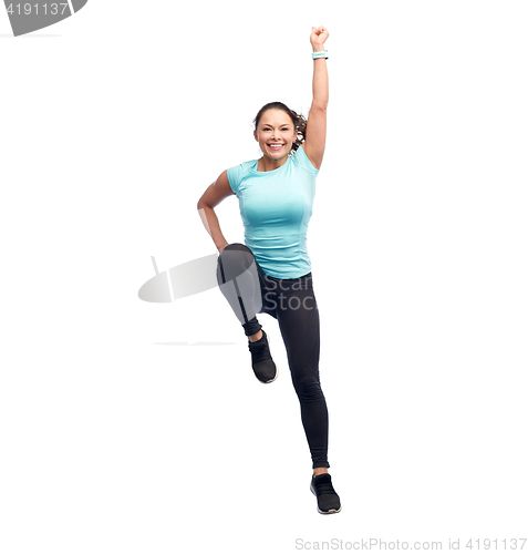 Image of happy smiling sporty young woman jumping in air