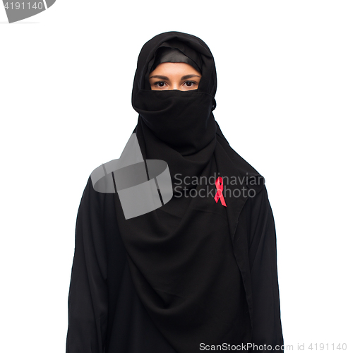 Image of muslim woman in hijab with red awareness ribbon