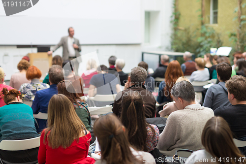 Image of Man giving presentation in lecture hall at university.