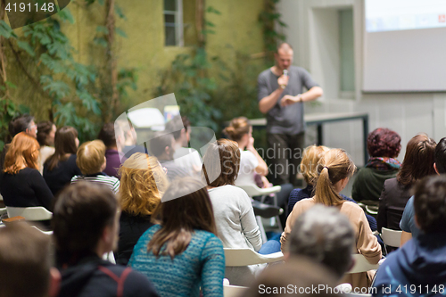 Image of Man giving presentation in lecture hall at university.