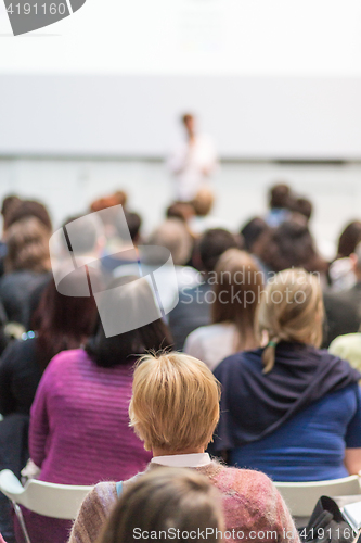 Image of Woman giving presentation in lecture hall at university.