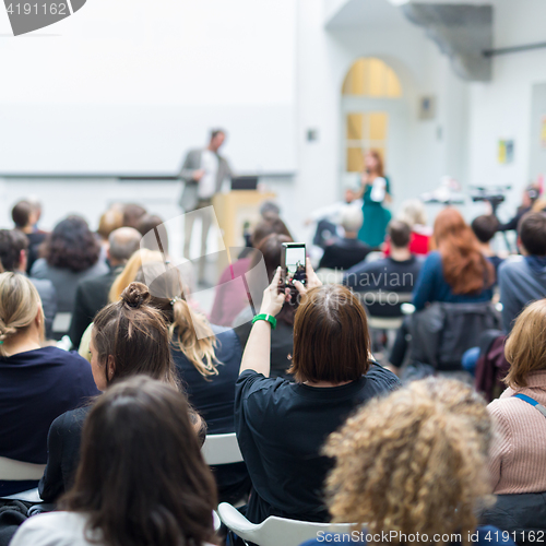 Image of Man giving presentation in lecture hall at university.