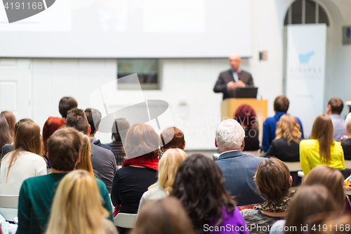 Image of Public speaker giving talk at Business Event.