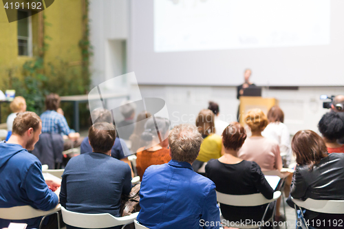 Image of Woman giving presentation in lecture hall at university.