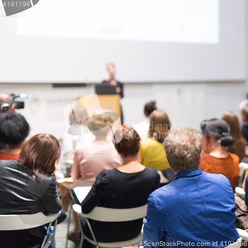 Image of Woman giving presentation in lecture hall at university.