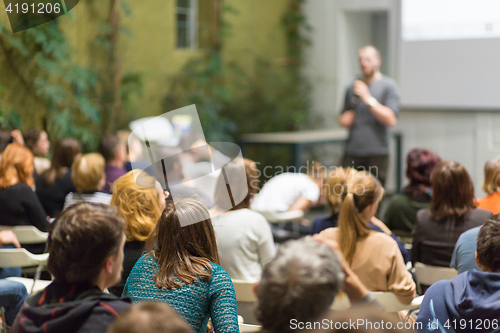 Image of Man giving presentation in lecture hall at university.