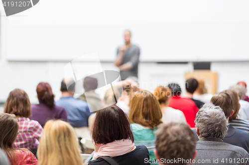 Image of Man giving presentation in lecture hall at university.