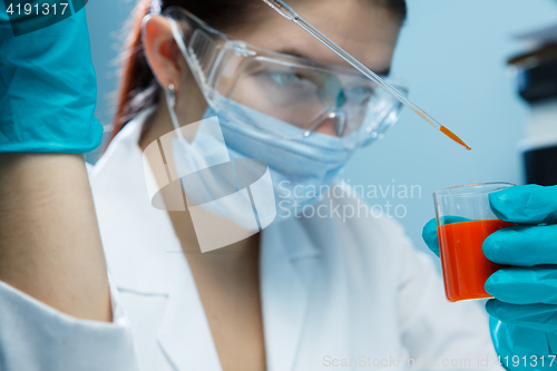 Image of Lab technician in mask , goggles