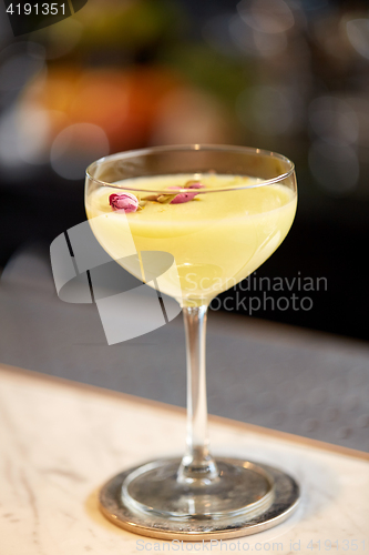 Image of glass of cocktail at bar or restaurant