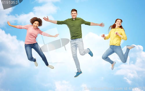 Image of smiling young man jumping in air