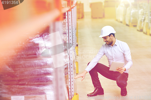 Image of happy businessman with tablet pc at warehouse