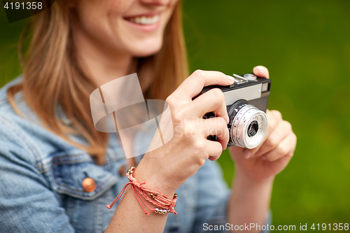 Image of close up of woman with camera shooting outdoors